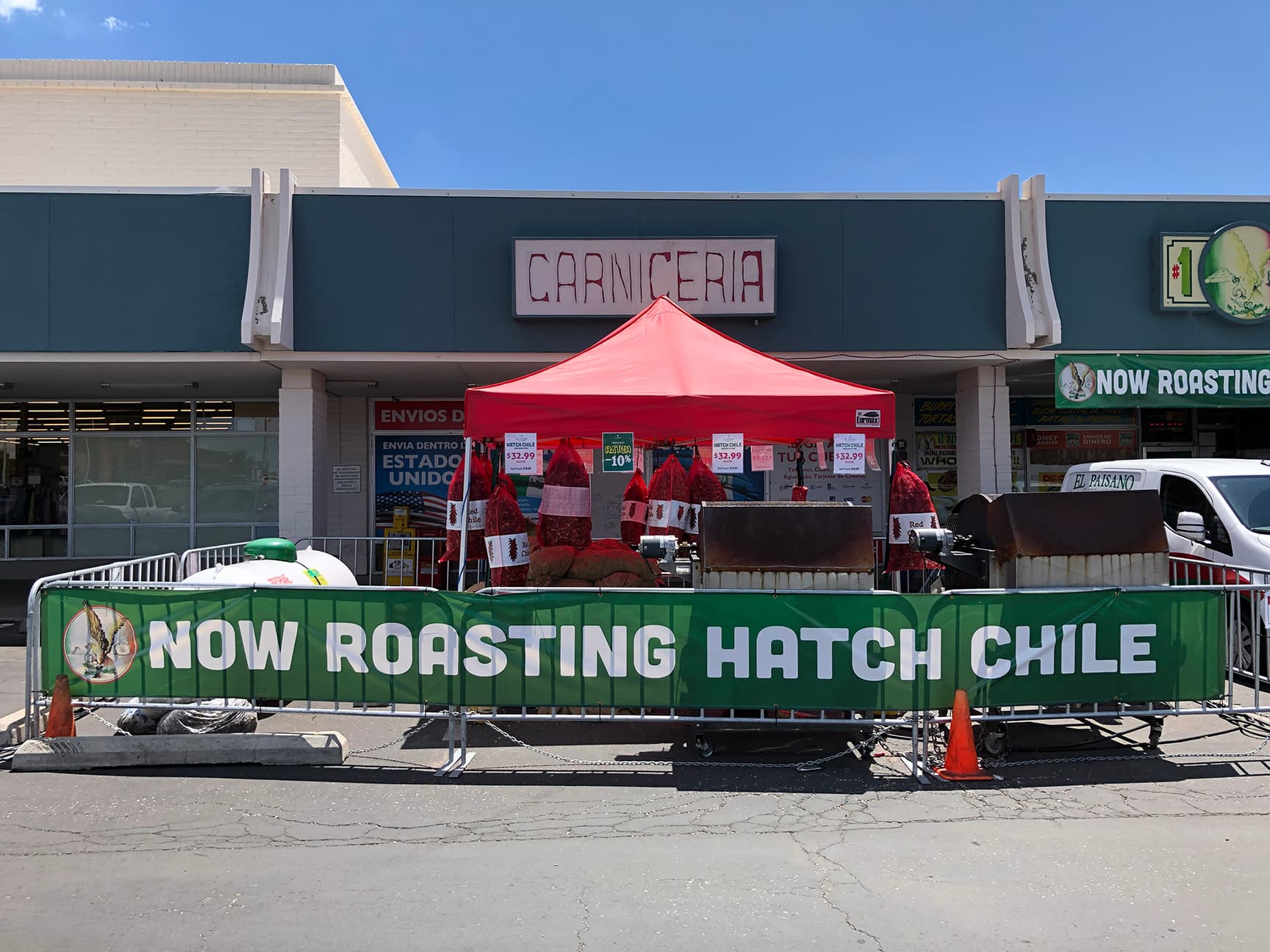 Hatch chile roasting in a drum roaster at a roadside stand