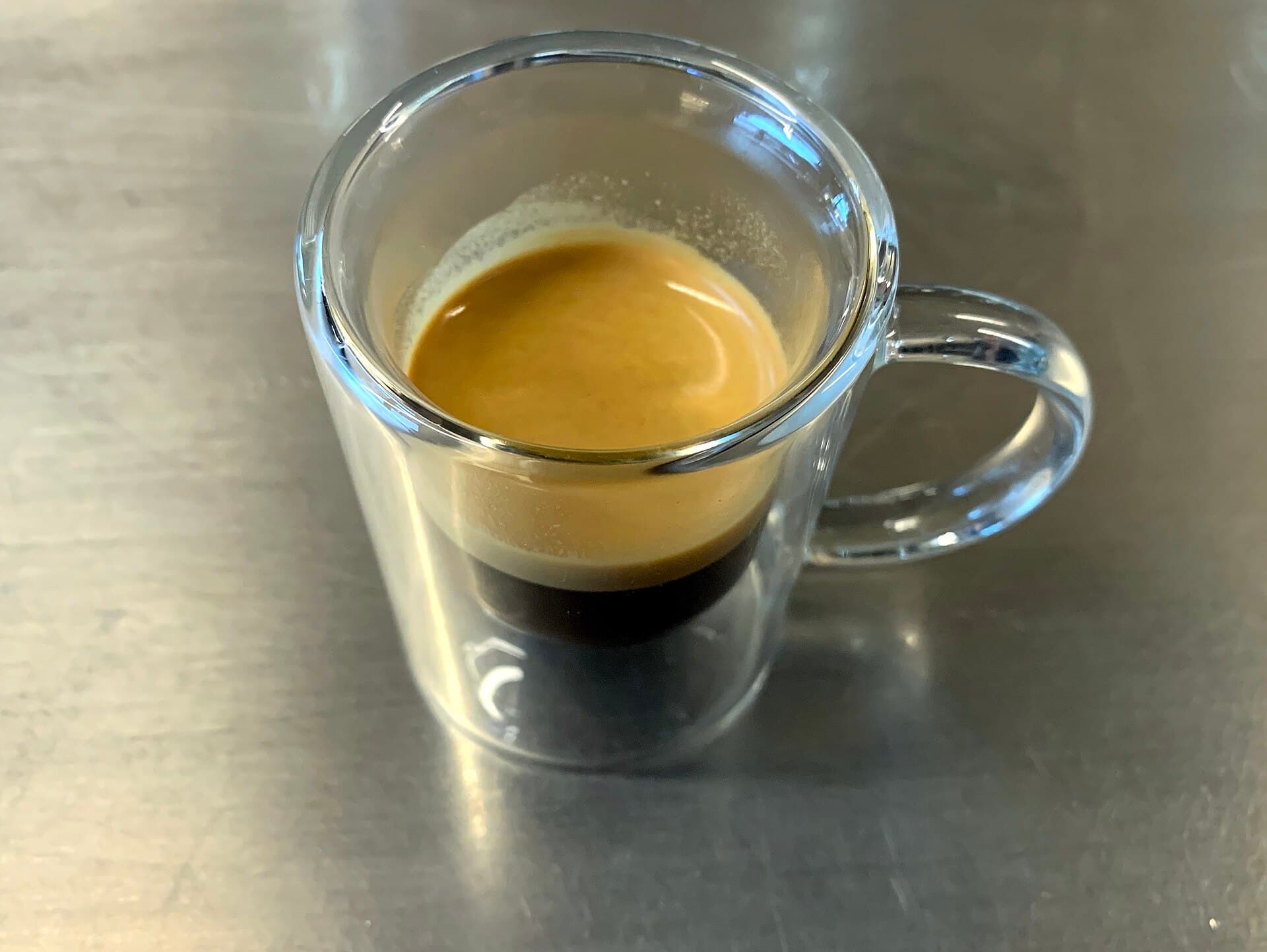 An espresso in a glass cup