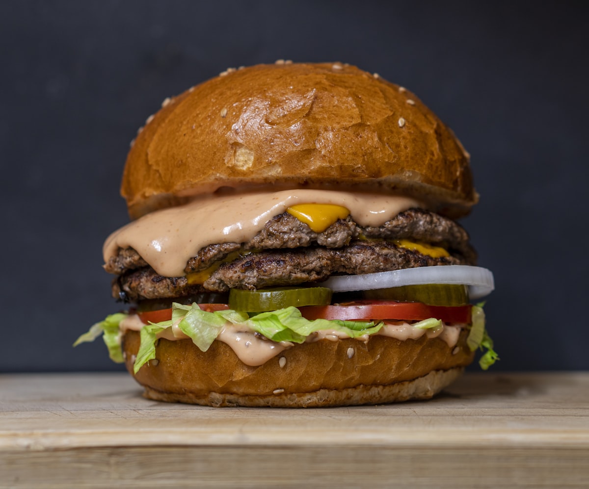 A green chile cheeseburger loaded with roasted green chile and melted cheese on a sesame bun