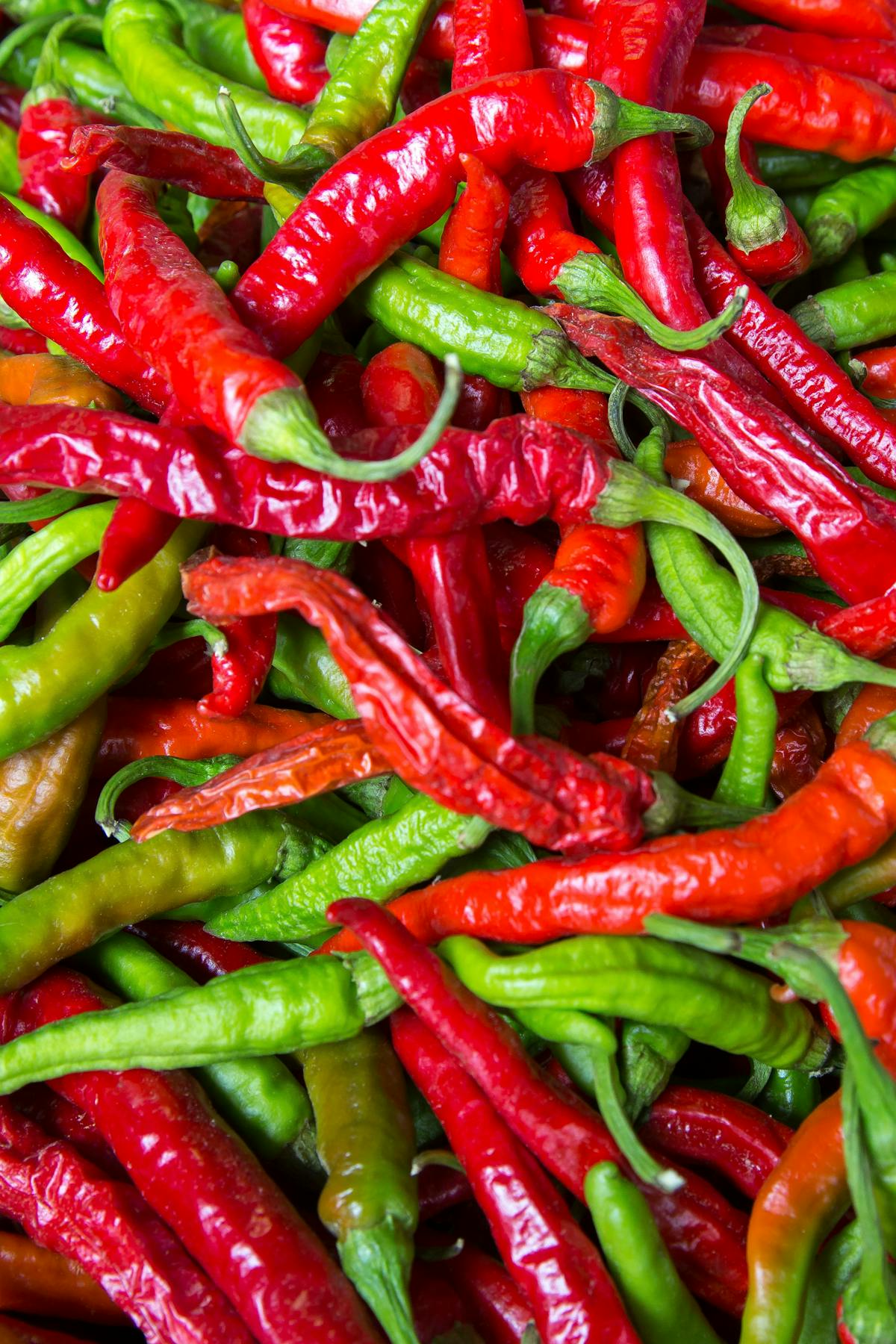Fresh green and red chile peppers piled high, the raw material for New Mexico's signature ingredient