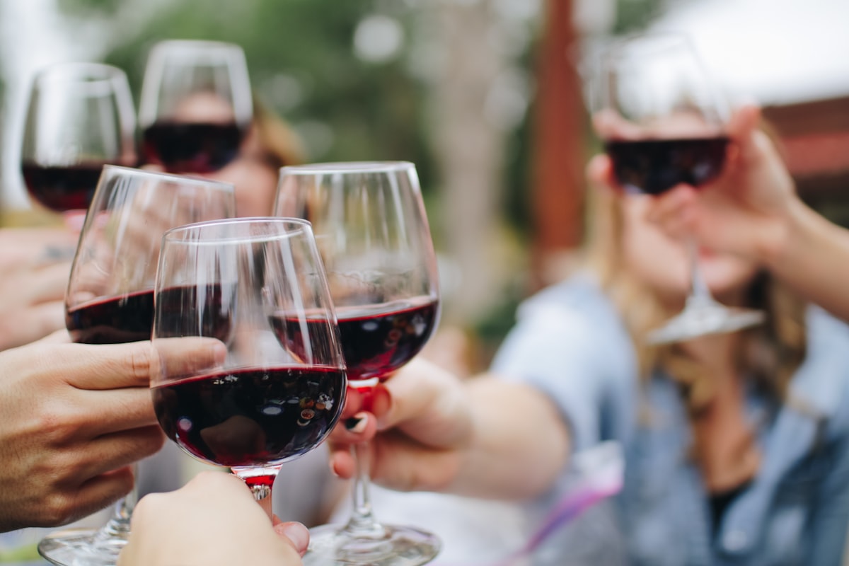 Wine tasting glasses lined up on a wood table for a flight